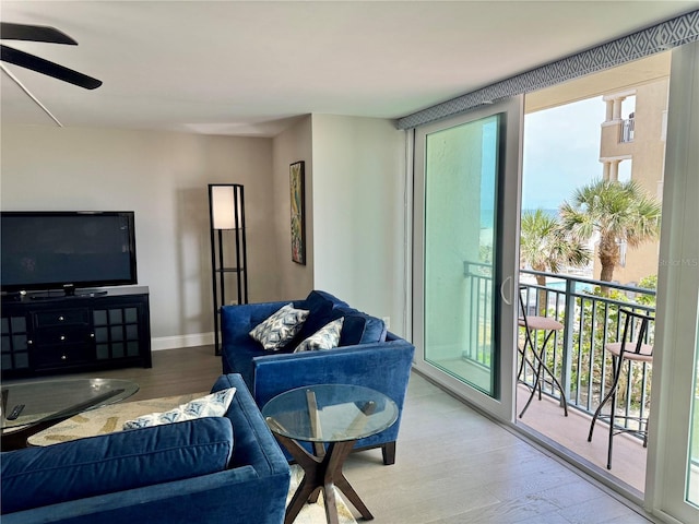 1390 Gulf Blvd Unit 104, Clearwater, FL 33767 - living area featuring healthy amount of natural light, wood finished floors, and a ceiling fan