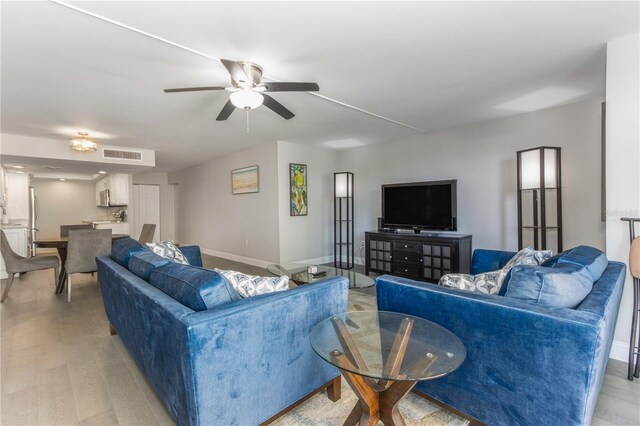 1390 Gulf Blvd Unit 104, Clearwater, FL 33767 - living room featuring a ceiling fan and light wood-style flooring