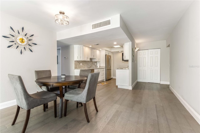 1390 Gulf Blvd Unit 104, Clearwater, FL 33767 - dining room with baseboards and light wood-type flooring