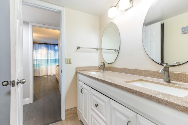 1390 Gulf Blvd Unit 104, Clearwater, FL 33767 - full bathroom featuring double vanity and wood finished floors