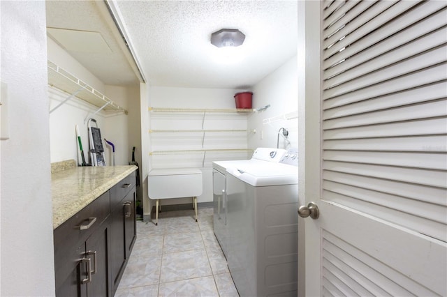 1390 Gulf Blvd Unit 104, Clearwater, FL 33767 - laundry room with independent washer and dryer, cabinet space, and a textured ceiling