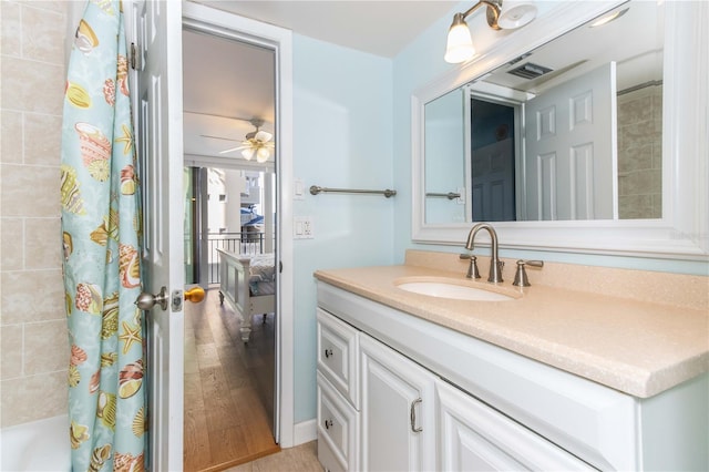 1390 Gulf Blvd Unit 104, Clearwater, FL 33767 - bathroom featuring vanity, wood finished floors, a ceiling fan, and shower / bathtub combination with curtain