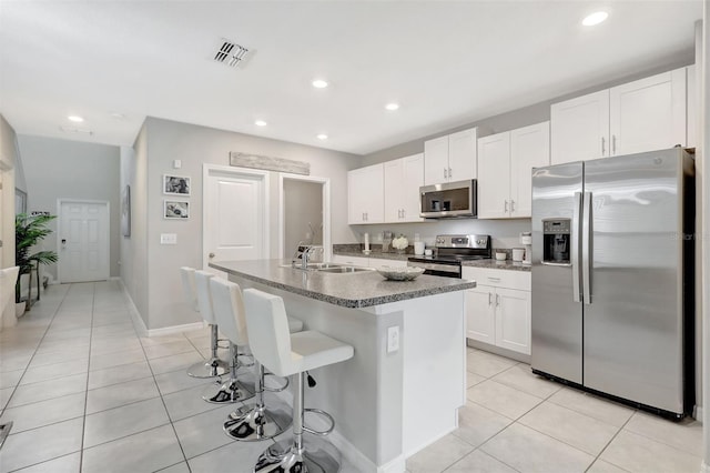 kitchen with a sink, visible vents, appliances with stainless steel finishes, and light tile patterned floors