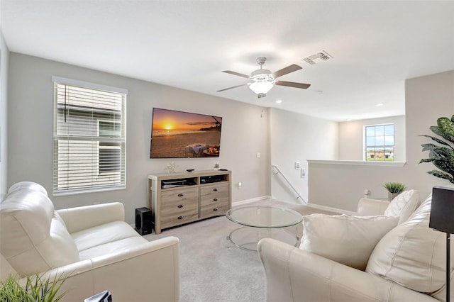 living area with visible vents, ceiling fan, recessed lighting, and light colored carpet