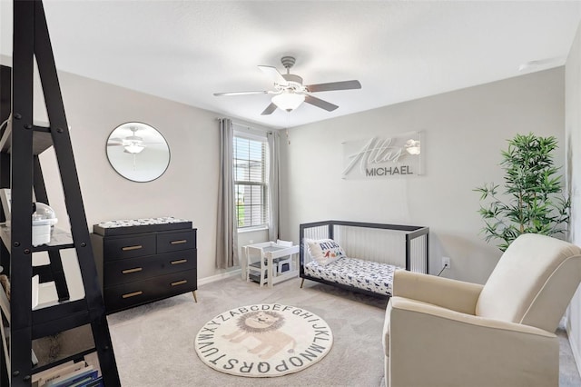 bedroom featuring light colored carpet, baseboards, and ceiling fan