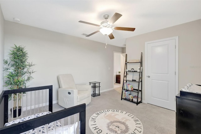 bedroom featuring light carpet, baseboards, and ceiling fan