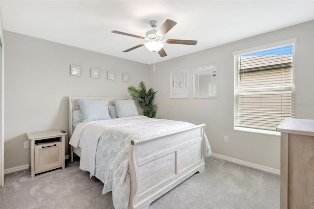 bedroom featuring light carpet, ceiling fan, and baseboards