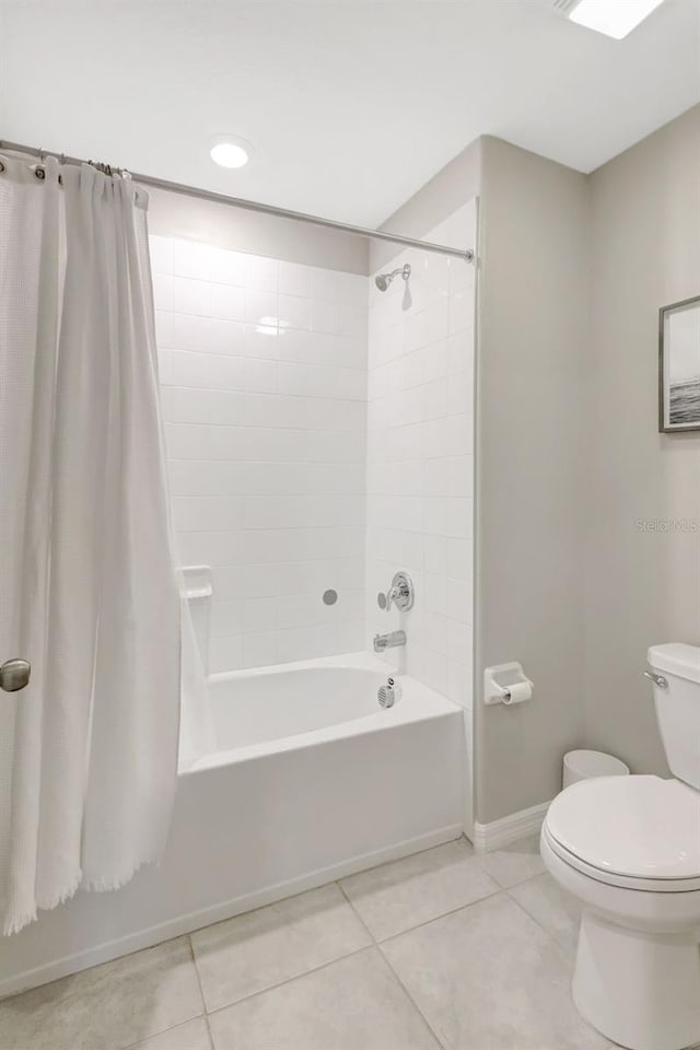 bathroom with toilet, tile patterned floors, shower / tub combo with curtain, and baseboards
