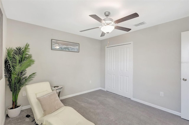 sitting room with visible vents, baseboards, a ceiling fan, and carpet floors