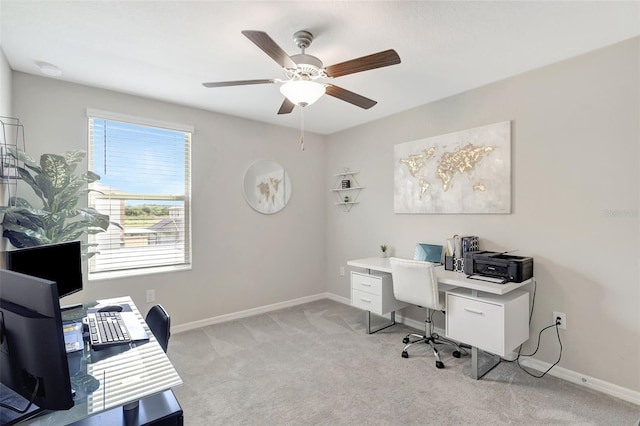 office featuring ceiling fan, light carpet, and baseboards