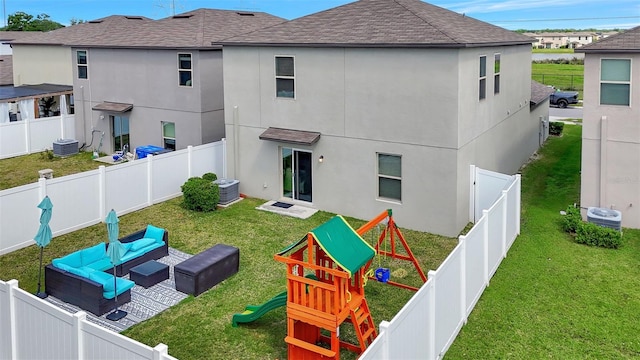 rear view of house featuring outdoor lounge area, stucco siding, a fenced backyard, a yard, and a playground