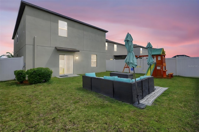 back of house with a yard, an outdoor hangout area, and a fenced backyard