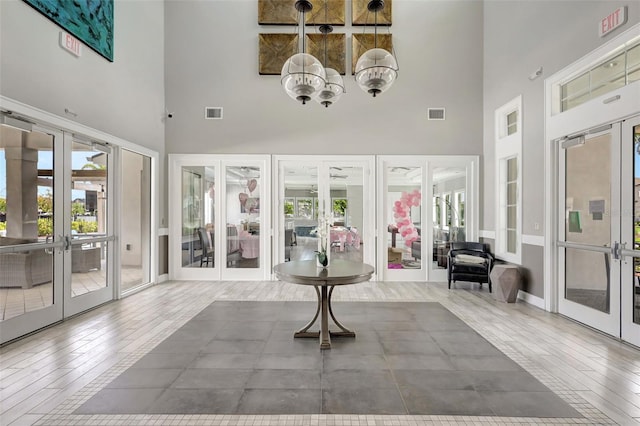 sunroom / solarium featuring french doors and visible vents