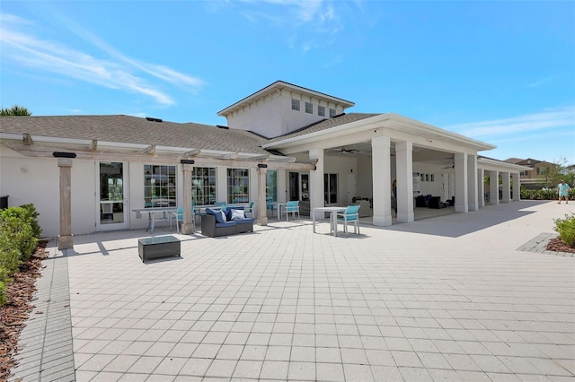 back of property featuring an outdoor living space, a ceiling fan, a patio, and stucco siding