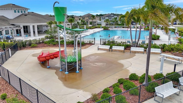 pool featuring a patio area, fence, and a residential view