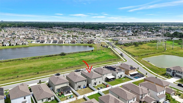 birds eye view of property with a water view and a residential view
