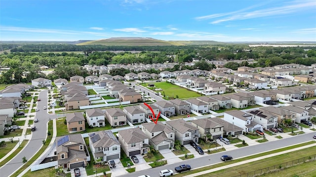 birds eye view of property with a mountain view and a residential view