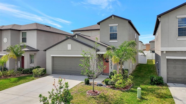 traditional-style house with an attached garage, driveway, and stucco siding