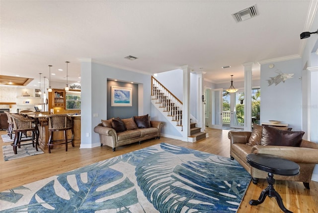 450 Bayshore Dr, Terra Ceia, FL 34250 - living area with light wood-style flooring, crown molding, and visible vents