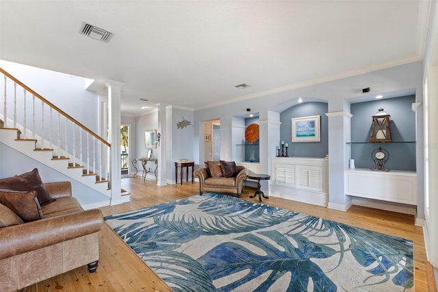 450 Bayshore Dr, Terra Ceia, FL 34250 - living area with visible vents, crown molding, baseboards, wood finished floors, and decorative columns