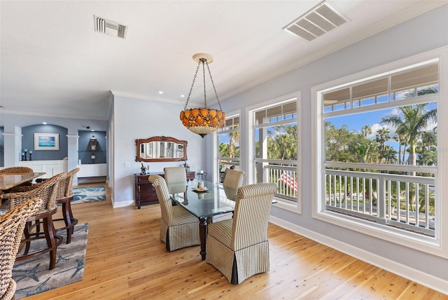 450 Bayshore Dr, Terra Ceia, FL 34250 - dining area with visible vents, a healthy amount of sunlight, and crown molding