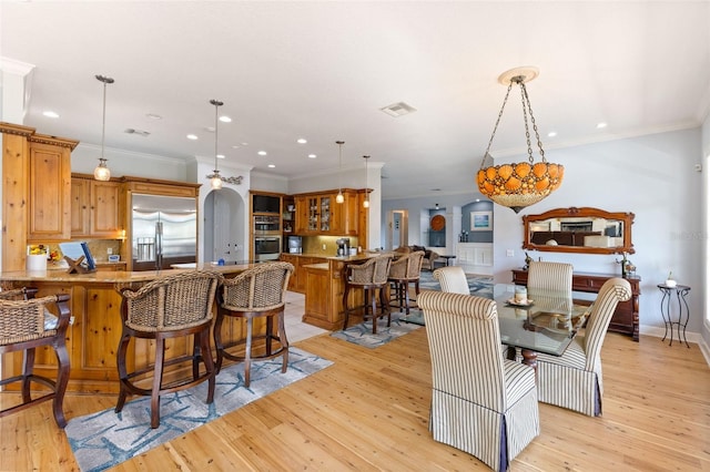 450 Bayshore Dr, Terra Ceia, FL 34250 - dining space with light wood-type flooring, recessed lighting, ornamental molding, and visible vents