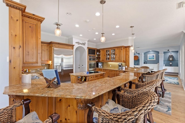 450 Bayshore Dr, Terra Ceia, FL 34250 - kitchen with light stone countertops, a sink, a peninsula, and appliances with stainless steel finishes