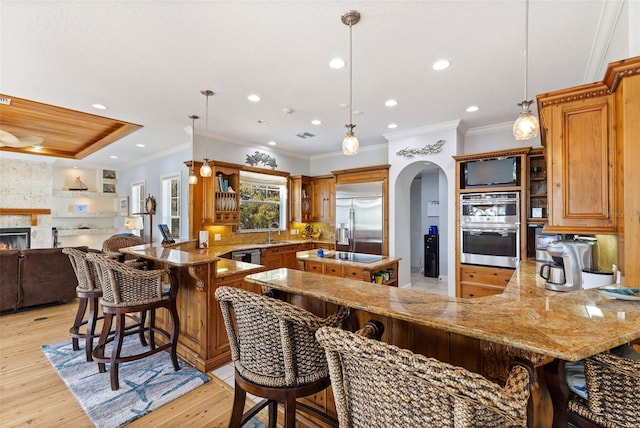 450 Bayshore Dr, Terra Ceia, FL 34250 - kitchen featuring light stone countertops, a peninsula, a sink, and stainless steel appliances