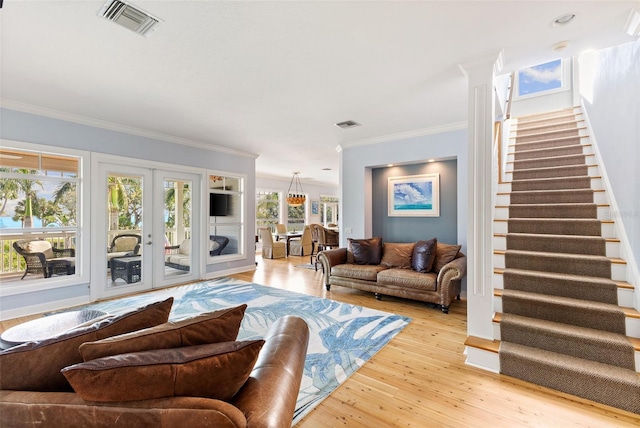 450 Bayshore Dr, Terra Ceia, FL 34250 - living room featuring french doors, stairway, visible vents, light wood-style floors, and ornamental molding