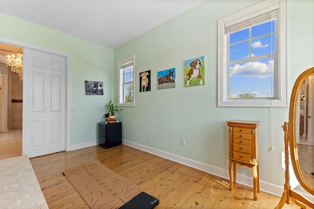 450 Bayshore Dr, Terra Ceia, FL 34250 - sitting room featuring baseboards, light wood-style floors, and a chandelier