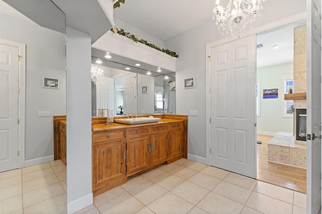 450 Bayshore Dr, Terra Ceia, FL 34250 - bathroom with visible vents, baseboards, vanity, an inviting chandelier, and tile patterned flooring