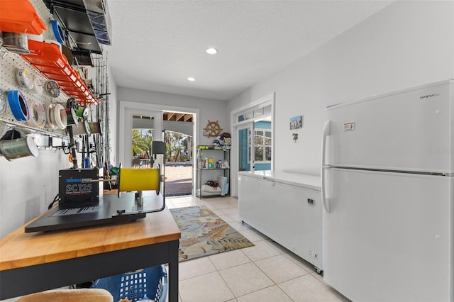 450 Bayshore Dr, Terra Ceia, FL 34250 - kitchen featuring recessed lighting, a textured ceiling, tile patterned floors, butcher block counters, and freestanding refrigerator
