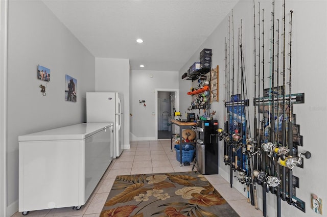 450 Bayshore Dr, Terra Ceia, FL 34250 - interior space with light countertops, fridge, recessed lighting, light tile patterned flooring, and freestanding refrigerator