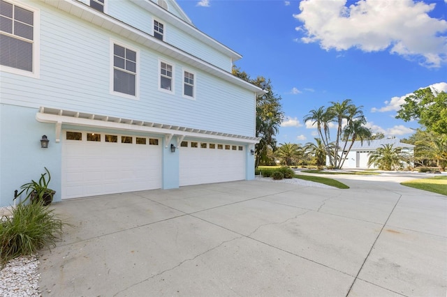 450 Bayshore Dr, Terra Ceia, FL 34250 - view of property exterior with driveway, stucco siding, and a garage