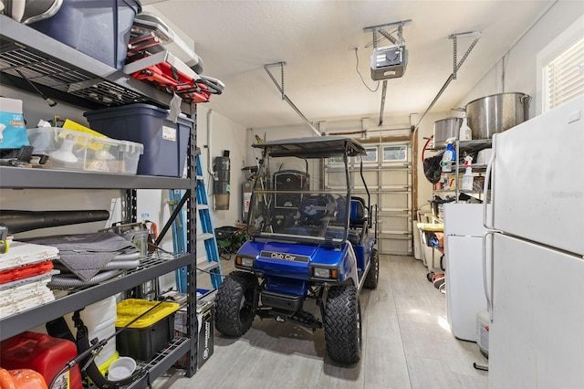 450 Bayshore Dr, Terra Ceia, FL 34250 - garage with freestanding refrigerator and a garage door opener