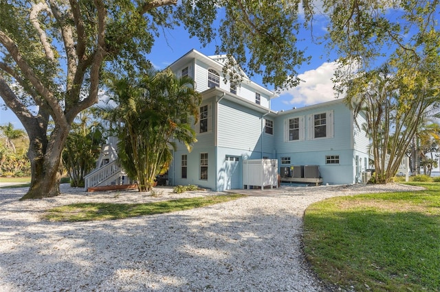 450 Bayshore Dr, Terra Ceia, FL 34250 - view of side of home featuring driveway and a yard