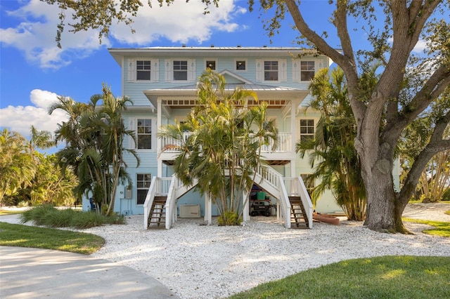 450 Bayshore Dr, Terra Ceia, FL 34250 - raised beach house featuring a porch and stairway