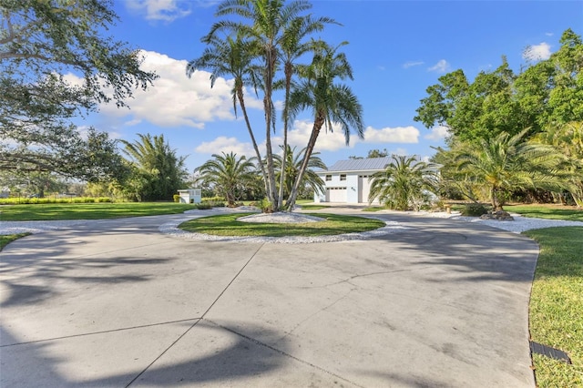 450 Bayshore Dr, Terra Ceia, FL 34250 - view of front of home featuring a front lawn and curved driveway