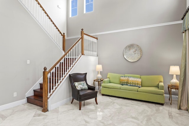 living room with marble finish floor, stairs, a towering ceiling, and baseboards