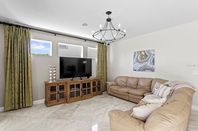 living area with an inviting chandelier and baseboards