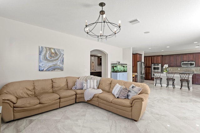 living room featuring recessed lighting, marble finish floor, arched walkways, visible vents, and a notable chandelier