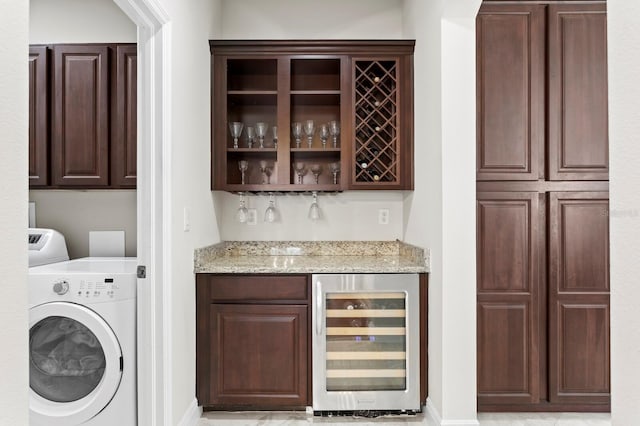 bar with wine cooler, a dry bar, and washer / clothes dryer