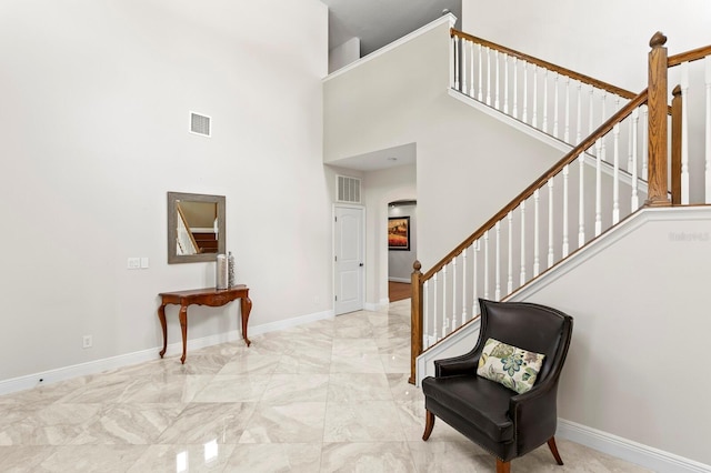 entrance foyer with marble finish floor, baseboards, and visible vents