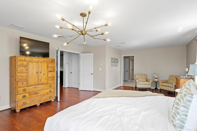 bedroom featuring an inviting chandelier, dark wood-type flooring, baseboards, and visible vents