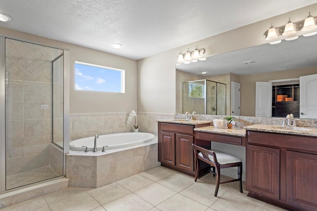 bathroom with a stall shower, tile patterned floors, a sink, a bath, and double vanity