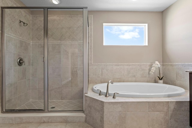 full bathroom featuring a garden tub and a shower stall