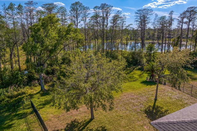 exterior space with a water view and fence