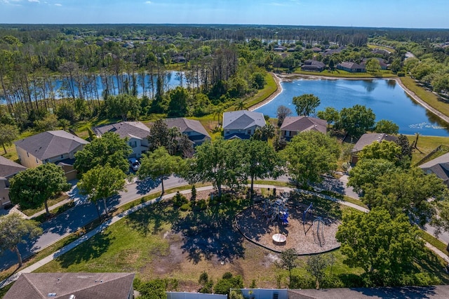 aerial view with a residential view, a water view, and a forest view