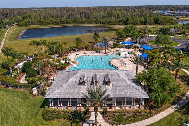 birds eye view of property featuring a forest view and a water view