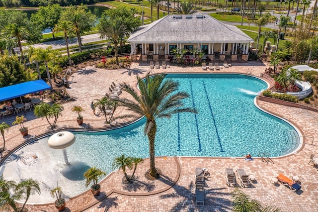 community pool with fence and a patio area
